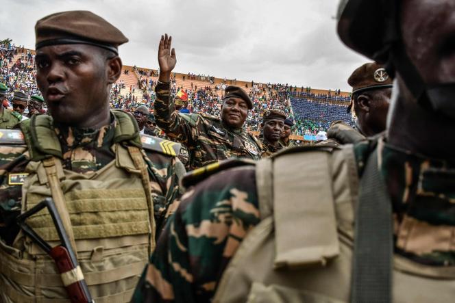 Le général Abdourahamane Tiani (au centre), chef du régime militaire au Niger, salue les milliers de personnes rassemblées dans le plus grand stade de Niamey pour le lancement des festivités marquant le premier anniversaire de son arrivée au pouvoir après le coup d’Etat du 26 juillet 2023 qui a renversé le président civil Mohamed Bazoum, le 26 juillet 2024.
