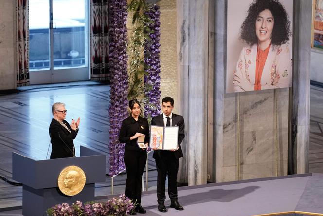 La présidente du comité Nobel, Berit Reiss-Andersen (à gauche), applaudit les enfants de Narges Mohammadi,  lors de la cérémonie de remise du prix Nobel de la paix, à Oslo, le 10 décembre 2023. 
