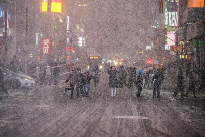  People admire the snow in Times Square on February 22, 2026 in New York City. 