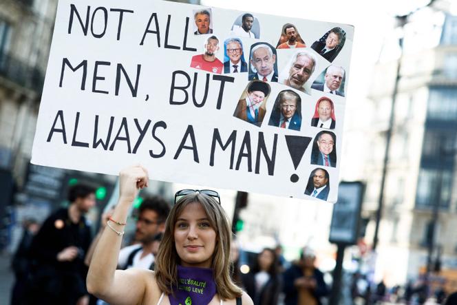 A protestor holds a sign reading 