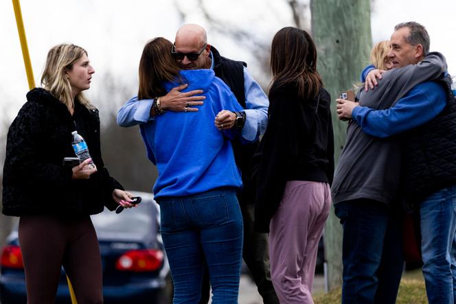 Funcionários e suas famílias se reúnem após serem escoltados pelas autoridades até seus carros após um ataque à sinagoga Temple Israel em West Bloomfield, Michigan, em 12 de março de 2026.