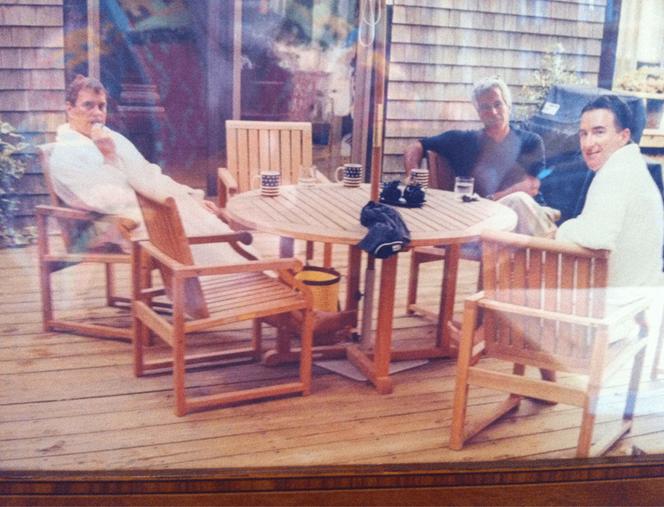 This undated photo in an unidentified location provided by the US Department of Justice on March 13, 2026 shows, Andrew Mountbatten-Windsor and Lord Peter Mandelson wearing bathrobes seated alongside late financier and convicted sex offender Jeffrey Epstein.