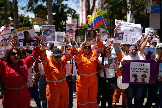 Parentes de petroleiros presos, vestidos com uniformes da PDVSA, manifestam-se em frente ao Supremo Tribunal Federal em Caracas, em 20 de março de 2026. 
