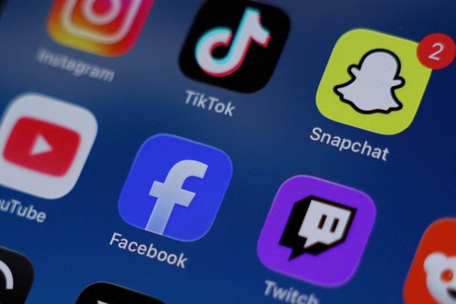 Instagram, TikTok, Snapchat, YouTube, Facebook, Twitch and Reddit applications are displayed on a mobile phone, December 9, 2025.
