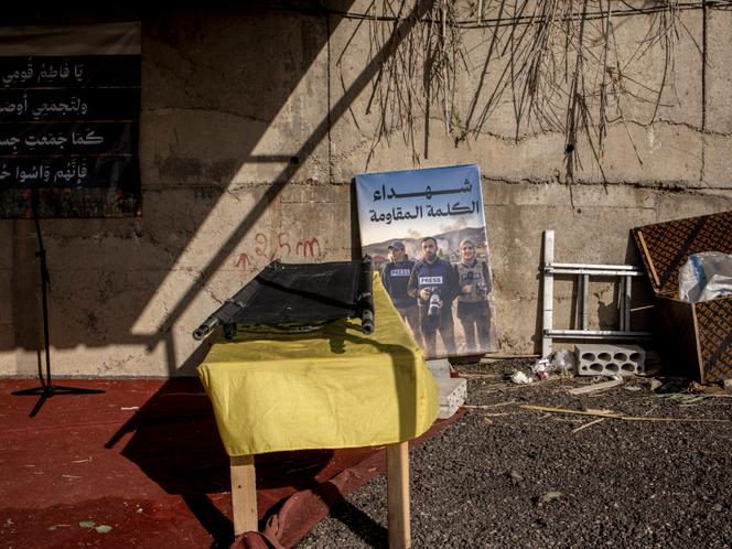 Une pancarte sur laquelle apparaissent les trois journalistes Ali Choeib, Fatima et Mohammed Ftouni, tués par une attaque de drone israélienne, dans un cimetière de la banlieue sud de Beyrouth, le 29 mars 2026.
