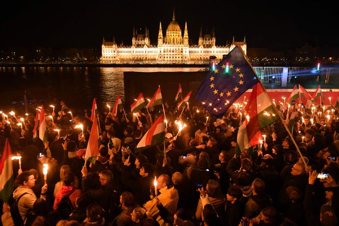 Apoiantes pró-europeus do partido Tisza, que se opõem ao Fidesz de Viktor Orban, celebram a sua vitória, em frente ao Parlamento, em Budapeste, em 12 de abril de 2026.