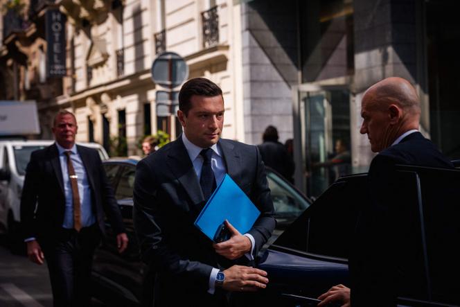 French far-right Rassemblement National (RN) President Jordan Bardella (C) arrives for a lunch meeting with French union Movement of the Enterprises of France (MEDEF) in Paris on April 20, 2026. 