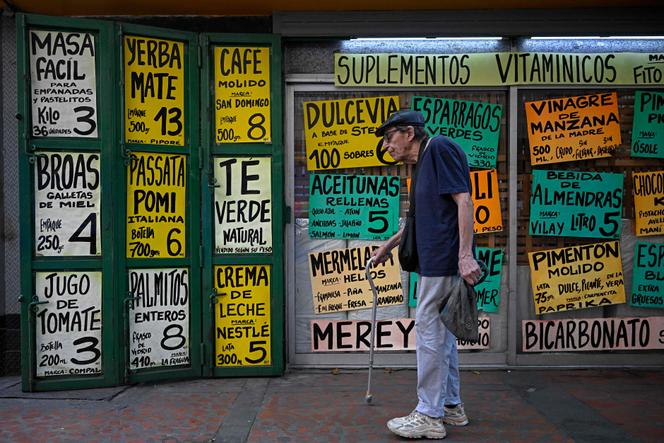 Em frente a um supermercado exibindo os preços dos alimentos em dólares americanos, em Caracas, 22 de abril de 2026.