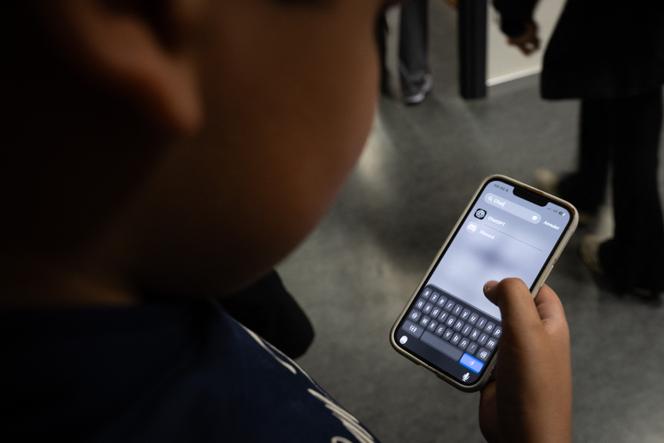 A student uses the ChatGPT app on their phone after a class on artificial intelligence at Jean Macé Middle School in Mulhouse, France, on March 26, 2026.