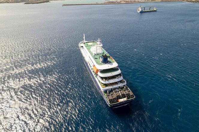 This aerial picture shows a general view of the cruise ship MV Hondius stationary off the port of Praia, the capital of Cape Verde, May 3, 2026. 