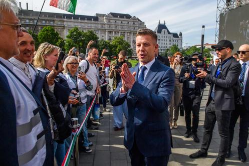Peter Magyar salue ses partisans rassemblés devant le Parlement avant son investiture, à Budapest, le 9 mai 2026.
