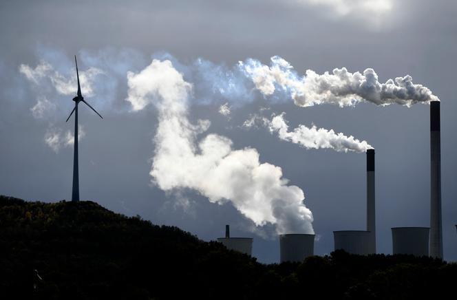 Steam escapes from a coal-fired power plant operated by global energy supplier Uniper, next to a wind turbine in Gelsenkirchen, western Germany, October 2, 2019.