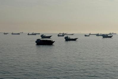 Vessels are seen anchored in the Strait of Hormuz, off the port city of Khasab on Oman’s northern Musandam Peninsula, May 17, 2026. 