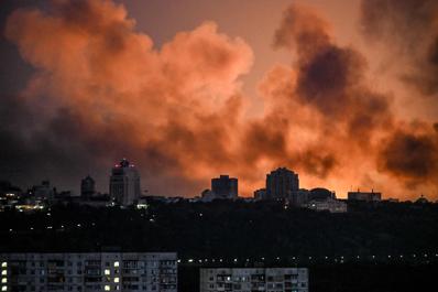 Smoke rises as the glow from fires light the sky during a Russian strike on Kyiv, Ukraine, May 24, 2026.