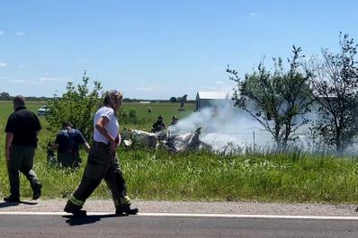 Firefighters work at the site of an aircraft crash in Butler, Missouri, in this still image taken from a video. June 14, 2026.