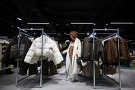 A customer looks at fast fashion clothes, in Paris, France, on November 5, 2025.