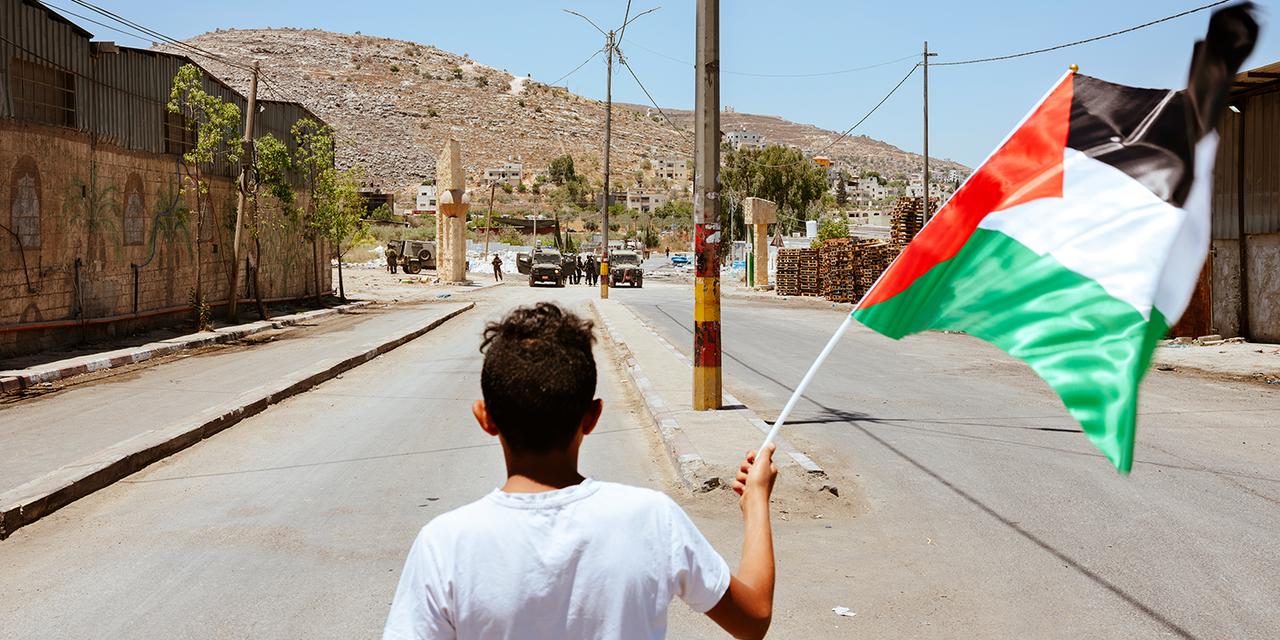 "I stand with nothing but the flag of my homeland against an army. I am backed by the villagers; they are backed by every unjust power. Free to kill, ready to carve another path of blood. Still, I stand here with my flag. Fearing only God, refusing to be oppressed, and carrying my flag as my only symbolic weapon." Beita, Nablus, Palestine, 2021