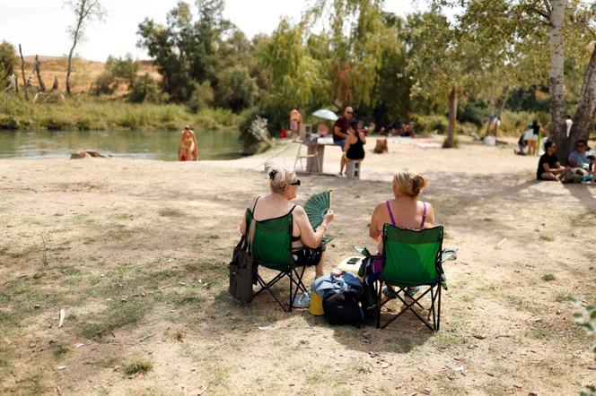 Des personnes se rafraîchissent au bord du Tage, à Estremera, en Espagne, le 5 septembre 2026. - OSCAR DEL POZO/AFP