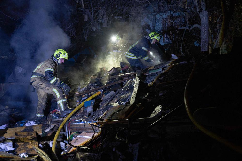 Ukrainian firefighters work at the site of a Russian missile strike at private houses in Kyiv late on October 21, 2026, amid the Russian invasion of Ukraine. (Photo by Genya SAVILOV / AFP) - GENYA SAVILOV/AFP