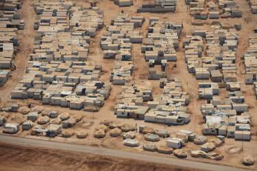 An aerial view shows the Zaatari refugee camp, near the Jordanian city of Mafraq July 18, 2013. U.S. Secretary of State John Kerry spent about 40 minutes with half a dozen refugees who vented their frustration at the international community's failure to end Syria's more than two-year-old civil war, while visiting the camp that holds roughly 115,000 Syrian refugees in Jordan about 12 km (eight miles) from the Syrian border. REUTERS/Mandel Ngan/Pool (JORDAN - Tags: POLITICS SOCIETY IMMIGRATION)