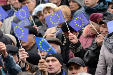 People wave European Union flags during  a rally in the western Ukrainian city of Lviv on November 24, 2013. Pro-West Ukrainians on Sunday staged the biggest protest rally in Kiev since the 2004 Orange Revolution, demanding that the government sign a key pact with the European Union and clashing with police. AFP PHOTO/ YURIY DYACHYSHYN