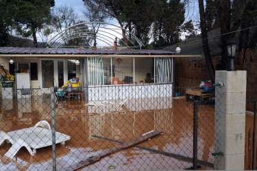 A view of a house surrounded by floodwaters after heavy rainfall the previous days, in Hyeres, on January 19, 2014. The Orange alert announced by French authorities in reponse to heavy rainfall and floods in southern France has been lifted today in the Bouches-du-Rhone region but maintained until tomorrow in the Var. AFP PHOTO / ANNE-CHRISTINE POUJOULAT