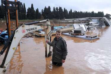 A man looks at his flooded farmlands after heavy rainfall the previous days, in Hyeres, on January 19, 2014. The Orange alert announced by French authorities in reponse to heavy rainfall and floods in southern France has been lifted today in the Bouches-du-Rhone region but maintained until tomorrow in the Var. AFP PHOTO / ANNE-CHRISTINE POUJOULAT