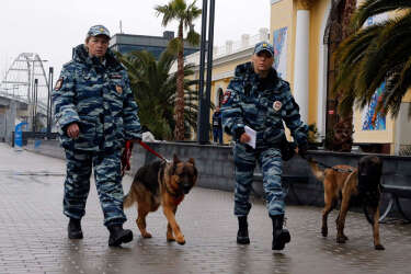 Russian police patrol outside a train station in the Adler district of Sochi, January 23, 2014. Sochi will host the 2014 Winter Olympic Games from February 7 to 23. REUTERS/Alexander Demianchuk (RUSSIA - Tags: SPORT OLYMPICS CITYSCAPE)