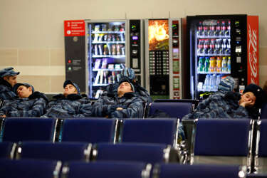 Members of Russia's security forces rest inside the train station of Krasnaya Polyana near Sochi, January 29, 2014. Sochi will host the 2014 Winter Olympic Games from February 7 to February 23. REUTERS/Kai Pfaffenbach (RUSSIA - Tags: SOCIETY SPORT OLYMPICS)