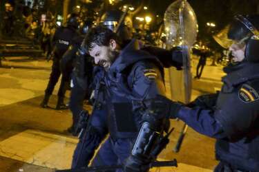 An injured anti-riot policeman reacts during clashes at the end of a march dubbed "the Marches for Dignity 22-M" to protest against austerity in Madrid on March 22, 2014. Eight columns of demonstrators, who have traveled from Andalusia, Catalonia, Asturias or Extremadura and other Spanish regions in an attempt to highlight the plight of struggling Spaniards, converged on Madrid today for a mass protest.   AFP PHOTO/ PEDRO ARMESTRE