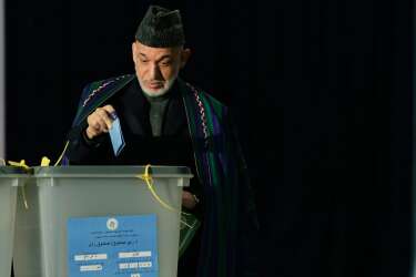 Afghan President Hamid Karzai casta his vote at a local polling station in Kabul on April 5, 2014. Afghan voters went to the polls to choose a successor to President Hamid Karzai, braving Taliban threats in a landmark election held as US-led forces wind down their long intervention in the country. Afghanistan's third presidential election brings an end to 13 years of rule by Karzai, who has held power since the Taliban were ousted in a US-led invasion in 2001, and will be the first democratic handover of power in the country's turbulent history.   TOPSHOTS/AFP PHOTO/Wakil KOHSAR