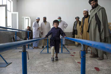 March 30, 2014 - Kandahar, Afghanistan - Mirwais Hospital sponsored by the Red Cross.A young boy tries a few steps on a new prosthetic leg fitted in the orthopedic ward.