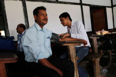 A polling officer (C) gets his medical check-up done before leaving for his assigned polling station at a distribution centre ahead of general elections in Jorhat district, in the northeastern Indian state of Assam April 6, 2014. India, the world's largest democracy, will hold its general election in nine stages staggered between April 7 and May 12. REUTERS/Adnan Abidi (INDIA - Tags: ELECTIONS POLITICS)