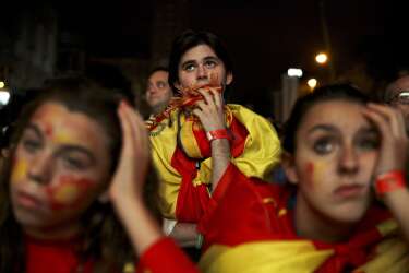 Spanish soccer fans watch on a giant display as the Netherlands soccer team wins the World Cup soccer match between Spain and Netherlands, in Madrid, Spain, Friday, June 13, 2014. (AP Photo/Daniel Ochoa de Olza)