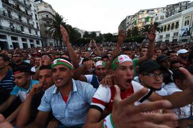 Algeria's fans react as they watch the FIFA 2014 World Cup football match Algeria vs South Korea on a big screen in central Algiers, on June 22, 2014. AFP PHOTO/FAROUK BATICHE