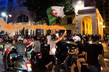 Algeria's football fans celebrate on the Canebiere in Marseille, southern France, on June 22, 2014 after Algeria defeated South Korea 4-2 in a FIFA 2014 World Cup Group H match. AFP PHOTO / BERTRAND LANGLOIS