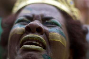 A Brazil soccer fan weeps as she watches Germany score repeatedly against Brazil at a World Cup semifinal match on a live telecast inside the FIFA Fan Fest area in Sao Paulo, Brazil, Tuesday, July 8, 2014. (AP Photo/Dario Lopez-Mills)