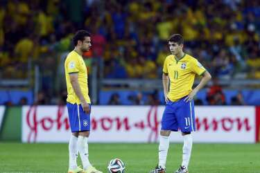 Brazil's Fred (L) and Oscar prepare to kick off at the start of the second half against Germany during their 2014 World Cup semi-finals at the Mineirao stadium in Belo Horizonte July 8, 2014. REUTERS/Eddie Keogh (BRAZIL  - Tags: SOCCER SPORT WORLD CUP)
