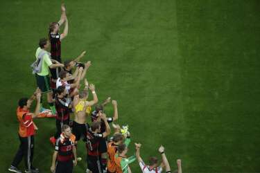 Germany's players celebrate after the semi-final football match between Brazil and Germany at The Mineirao Stadium in Belo Horizonte during the 2014 FIFA World Cup on July 8, 2014. AFP PHOTO / POOL /  FELIPE DANA