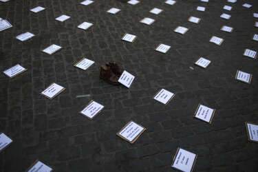 Banners with the names of every Palestinian person recently killed by  Israeli airstrikes  on the Gaza strip are laid out on the ground, following a protest,  in Barcelona, Spain, Thursday, July 17, 2014. About 2,000 people took part in the demonstration.  (AP Photo/Emilio Morenatti)