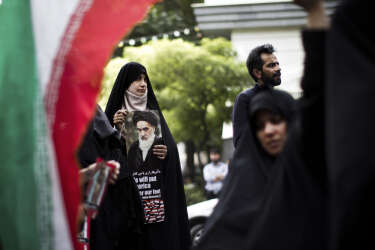 Iranian women hold anti-Israel placards and portraits of the late founder of the Islamic republic Ayatollah Ruhollah Khomeini outside the United Nations offices in Tehran on July 15, 2014 during a demonstration held by a small group of protestors against Israel's air strikes on the Gaza Strip this month. AFP PHOTO/BEHROUZ MEHRI