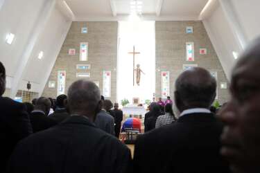 People attend a family ceremony for former Haitian dictator Jean-Claude Duvalier at the chapel of the school Saint-Louis Gonzague in Port-au-Prince on October 11, 2014. Duvalier, who died last week at age 63, was not granted a state funeral, his lawyer said October 9, after public outrage that a man accused of corruption and mass killings could receive such an honor. The Duvalier family lawyer, Reynold George, expressed bitterness that the government, "rather than stand by its principles, has ceded to pressure from certain figures."   AFP PHOTO/Hector RETAMAL