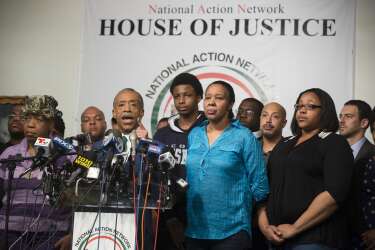 Rev. Al Sharpton speaks alongside Gwen Carr, mother of Eric Garner, left, Esaw Garner, Garner's wife, center right, and Emerald Garner, Garner's daughter, second from right, at the National Action Network headquarters in New York on Wednesday, Dec. 3, 2014 after a grand jury's decision not to indict a New York police officer involved in the death of Eric Garner. A video shot by an onlooker and widely viewed on the Internet showed the 43-year-old Garner telling a group of police officers to leave him alone as they tried to arrest him. The city medical examiner ruled Garner's death a homicide and found that a chokehold contributed to it. (AP Photo/John Minchillo)