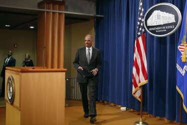 U.S. Attorney General Eric Holder arrives to make a statement about the grand jury decision not to seek an indictment in the Staten Island death of Eric Garner during an arrest in July, in Washington December 3, 2014. A New York City grand jury decision not to charge white police officer Daniel Pantaleo who killed unarmed black man Garner with a chokehold sparked outrage and protests on Wednesday, and the U.S. Justice Department said it would investigate the incident. REUTERS/Yuri Gripas (UNITED STATES - Tags: POLITICS CRIME LAW)