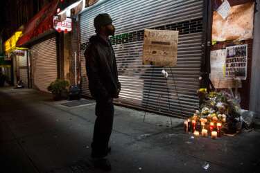 NEW YORK, NY - DECEMBER 03: A man pauses at an makeshift memorial for Eric Garner, the man killed by a police officer in July using a chokehold, outside the beauty salon where the confrontation took place on December 3, 2014 in the Staten Island borough of New York City. A grand jury declined to indict New York City Police Officer Daniel Pantaleo in Garner's death.   Andrew Burton/Getty Images/AFP
== FOR NEWSPAPERS, INTERNET, TELCOS & TELEVISION USE ONLY ==