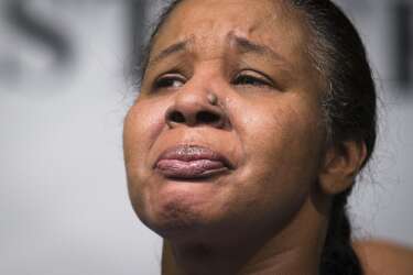 Esaw Garner, wife of Eric Garner, attends a news conference at the National Action Network headquarters in New York on Wednesday, Dec. 3, 2014 after a grand jury's decision not to indict a New York police officer involved in her husband's death. A video shot by an onlooker and widely viewed on the Internet showed the 43-year-old Garner telling a group of police officers to leave him alone as they tried to arrest him. The city medical examiner ruled Garner's death a homicide and found that a chokehold contributed to it. (AP Photo/John Minchillo)