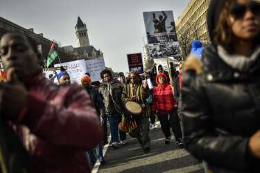 Demonstrators march to Capitol Hill in a protest against police violence organized by the National Action Network in Washington December 13, 2014. Thousands of demonstrators gathered in Washington on Saturday for a march to protest the killings of unarmed black men by law enforcement officers and to urge Congress to do more to protect African-Americans from unjustified police violence. REUTERS/James Lawler Duggan   (UNITED STATES - Tags: POLITICS CRIME LAW CIVIL UNREST)