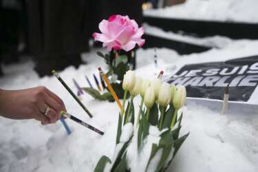 Montrealers place pencils in front of the French Consulate, in tribute to the victims of the shootings by gunmen at the offices of the satirical weekly newspaper Charlie Hebdo in Paris, in downtown Montreal, January 11, 2015. French citizens will be joined by dozens of foreign leaders, among them Arab and Muslim representatives, in a march on Sunday in an unprecedented tribute to this week's victims, including journalists and policemen, following the shootings by gunmen at the offices of the satirical weekly newspaper Charlie Hebdo, the killing of a police woman in Montrouge, and the hostage taking at a kosher supermarket at the Porte de Vincennes. REUTERS/Christinne Muschi (CANADA - Tags: CIVIL UNREST CRIME LAW)