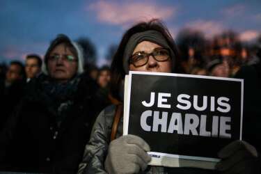 A participant holds a placard reading 'Je suis Charlie' (I am Charlie) during a rally themed 'Together against terror' on January 11, 2015 at the Ballhausplatz in Vienna in tribute to the 17 people killed in the terror attacks in France. The killings began on January 7 with an assault on the Charlie Hebdo satirical magazine in Paris that saw two brothers massacre 12 people including some of the country's best-known cartoonists, the killing of a policewoman and the storming of a Jewish supermarket on the eastern fringes of the capital which killed 4 local residents. AFP PHOTO / PATRICK DOMINGO