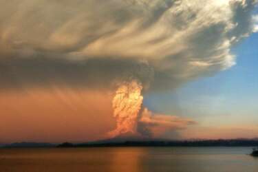 View from Puerto Varas, southern Chile, of a high column of ash and lava spewing from the Calbuco volcano, on April 22, 2015. Chile's Calbuco volcano erupted on Wednesday, spewing a giant funnel of ash high into the sky near the southern port city of Puerto Montt and triggering a red alert. Authorities ordered an evacuation for a 10-kilometer (six-mile) radius around the volcano, which is the second in southern Chile to have a substantial eruption since March 3, when the Villarrica volcano emitted a brief but fiery burst of ash and lava. AFP PHOTO/GIORDANA SCHMIDT  BEST QUALITY AVAILABLE